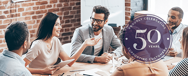 A group of people discussing around a table.