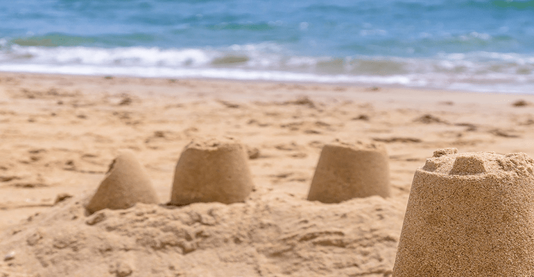 beach with sandcastles and the sea - l