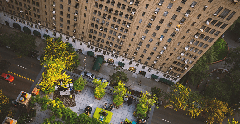 birds eye view of an office block with a group of people sat outside - l