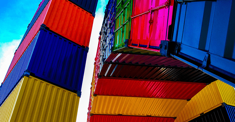 brightly coloured shipping containers stacked on top of each other - l