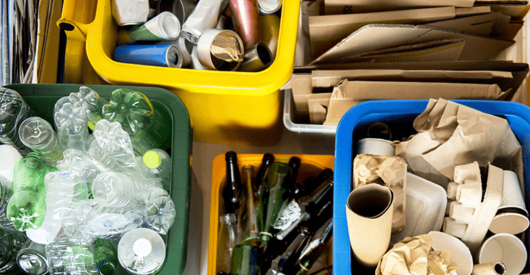 Different coloured recycling bins with the right items in it.