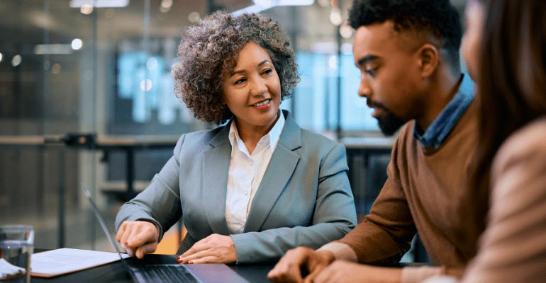 Female advisor explaining to a young male entrepreneur.