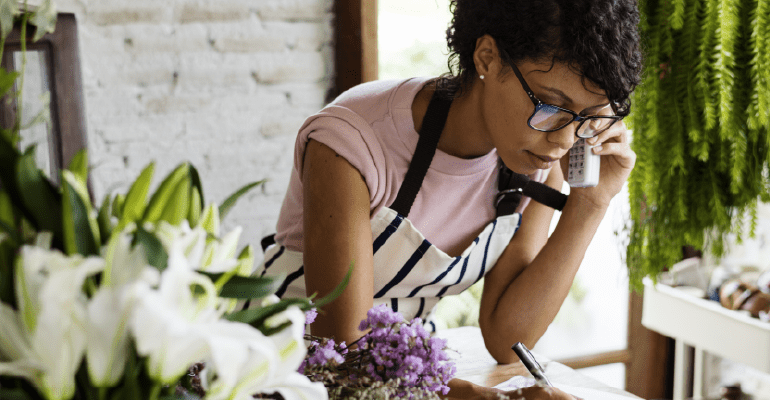 Female florist on the phone.