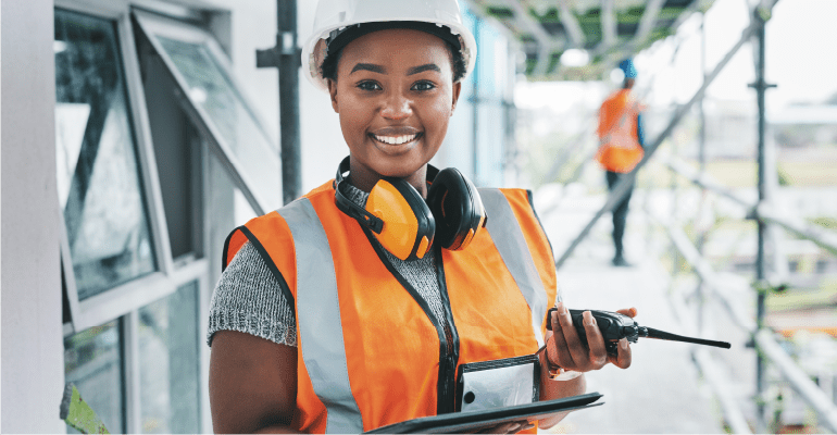 Female Project Manager on building site with scaffolding.