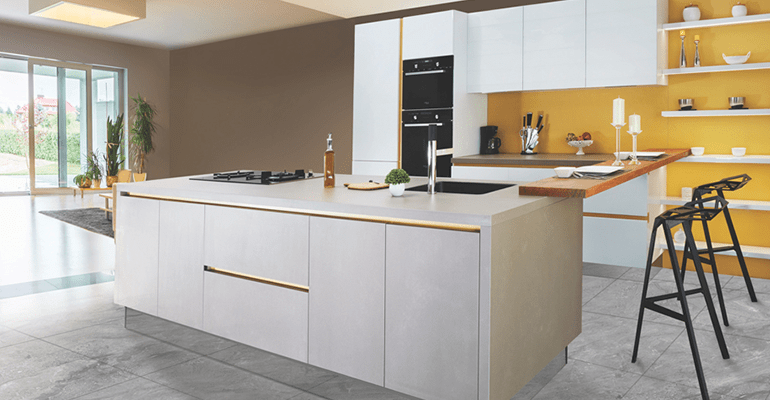 modern white kitchen with large island and yellow walls - l