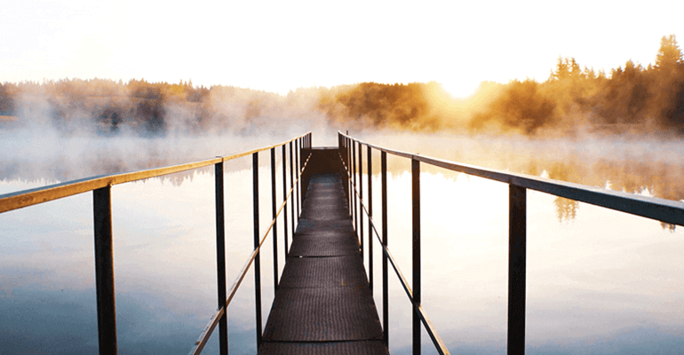 narrow bridge over a misty lake - l