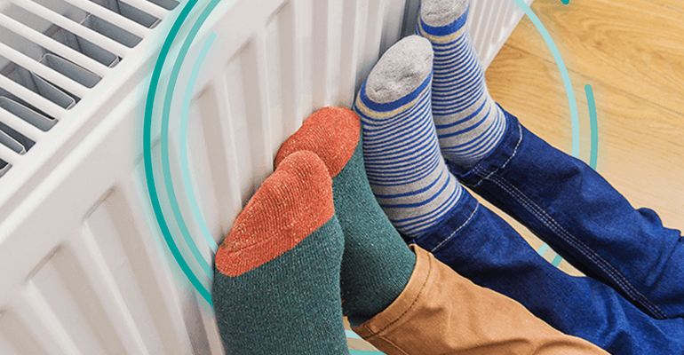 Two pairs of feet with different coloured socks on a radiator - medium large2