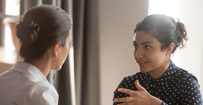 Two women discussing something.