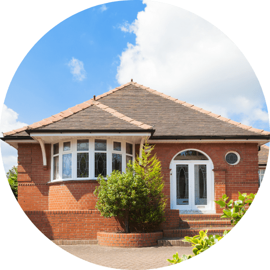 front of a bungalow on a sunny day