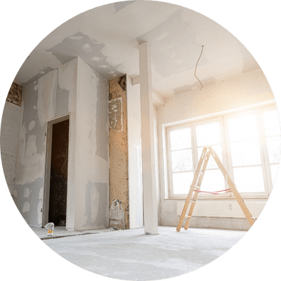 interior refurbishment in bare room with step ladder and sun shinning through a window