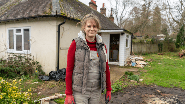 Female standing outside bungalow.