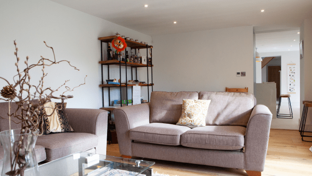 Stylish living room with sofa and wooden floor.