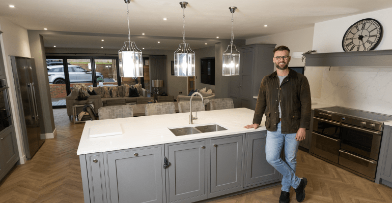 Darryl Cullerton leaning against a kitchen island.