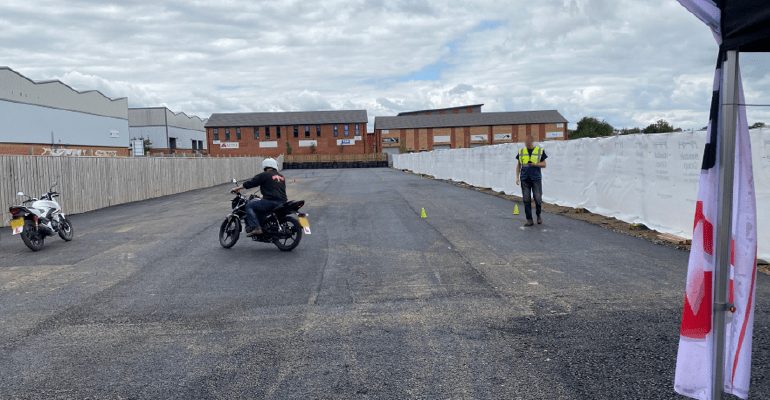 Man riding motorcycle on a track.