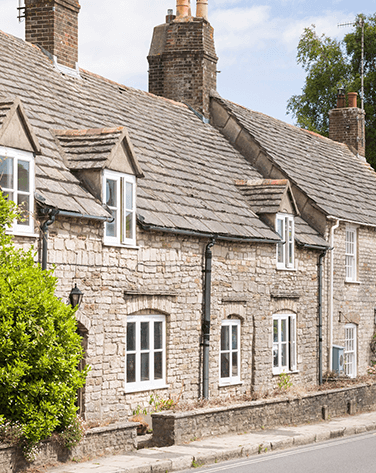 A wide shot of stone terraced houses on a street.