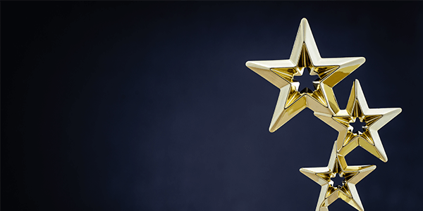 A dark blue background with an award on the right shaped like three stars.