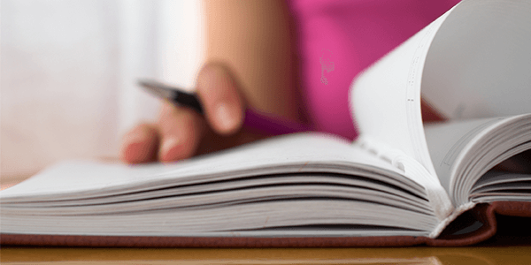 A close up of a woman reading a guide.