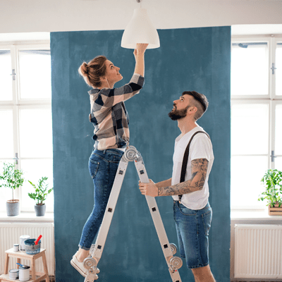 Adults couple changing light bulb indoors at home - l