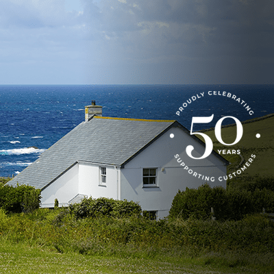 A long shot of a house by the sea.