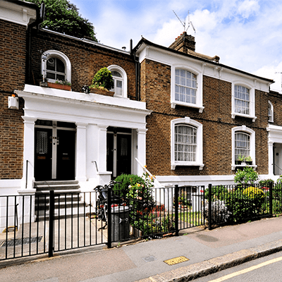 A row of brick terraced houses.