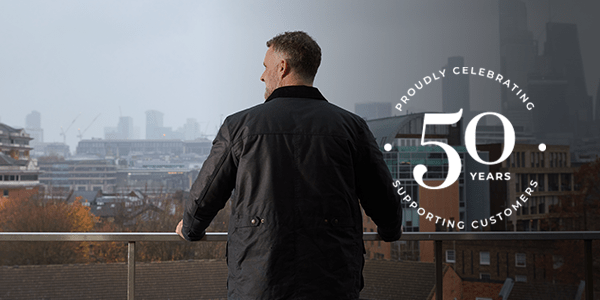 A wide shot of a man looking out at London.