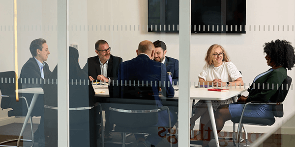 A group of colleages discussing in a meeting room 