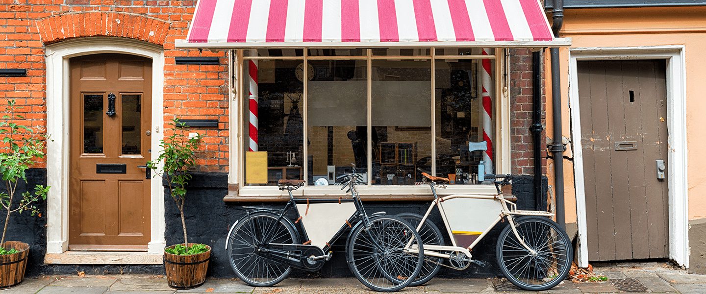 A traditional barber shop with bicycles outside - l