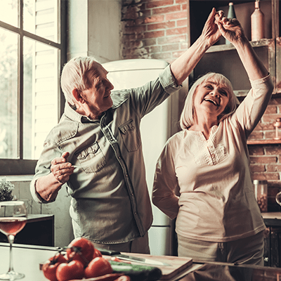 older couple dancing in their kitchen