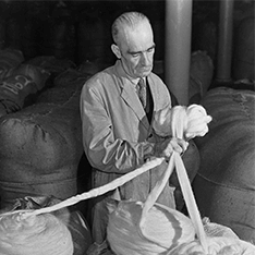 A black and white long shot of a man working.