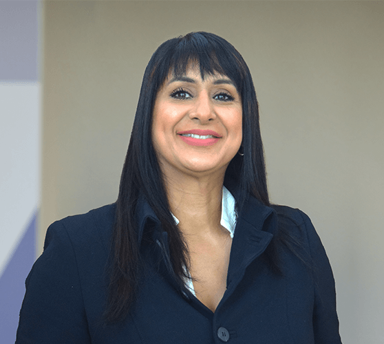 A woman with long black hair smiling wearing a black shirt.