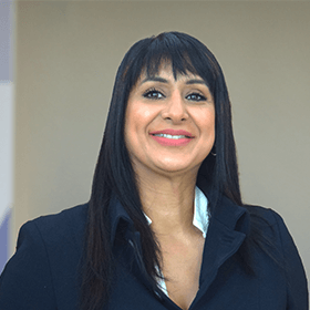 A woman with long black hair smiling wearing a black shirt.