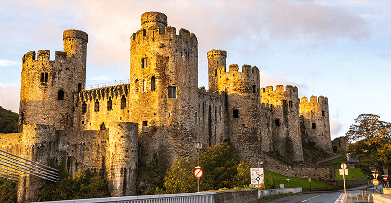 Conwy castle pictured with a bridge in foreground.