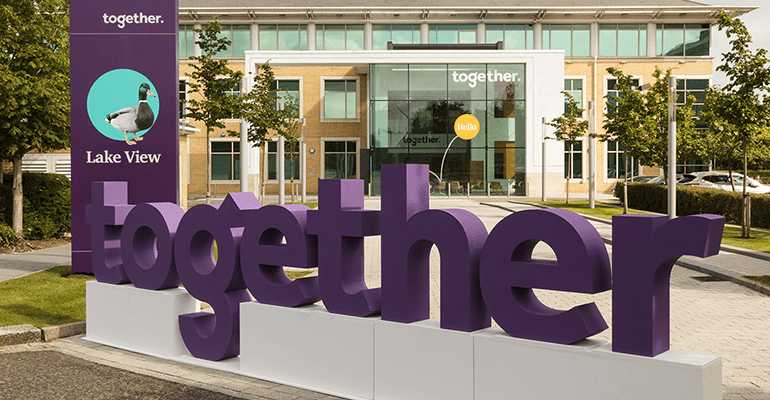 Together's logo in front of the company's building.