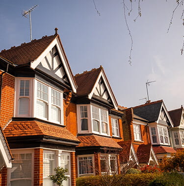 A long shot of brick houses next to each other.