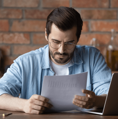 man in casual clothes reading documents