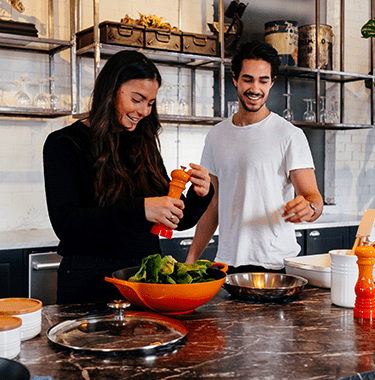 young couple cooking in a kitchen - l