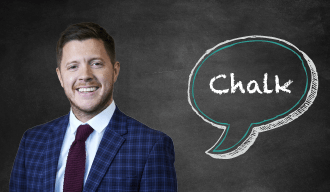 Blackboard with speech bubble saying Chalk on the right and a man in a blue suit on the left 