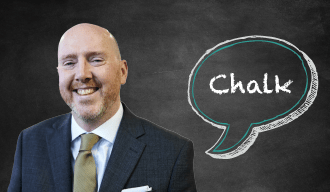 Blackboard with speech bubble saying Chalk on the right and a bald man in a black suit